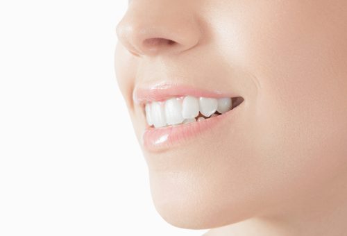 Healthy woman teeth and smile. Isolated over white background.